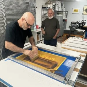 Printer Pepe Coronado and artist Benito Huerta working on a print at Coronado Printstudio