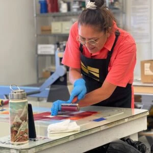 Ka’ila Farrell-Smith working on a print at Crow’s Shadow Institute of the Arts