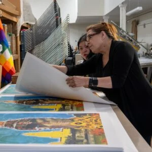 Artist Consuelo Flores and Studio Assistant Gabby Claro reviewing prints at Self Help Graphics and Art